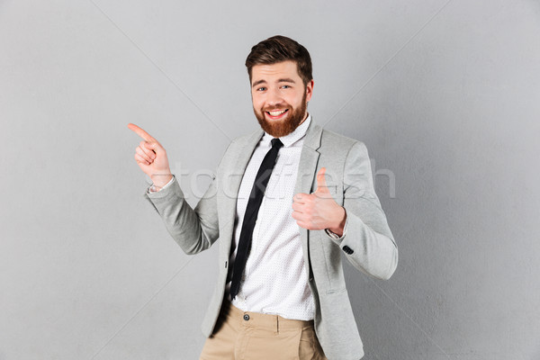 Stockfoto: Portret · opgewonden · zakenman · pak · wijzend · vinger