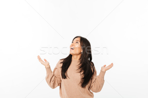 Asian excited surprised lady looking aside. Stock photo © deandrobot