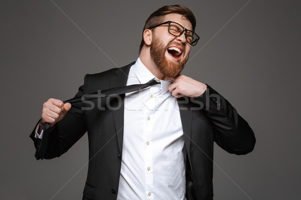Portrait of an angry young businessman Stock photo © deandrobot