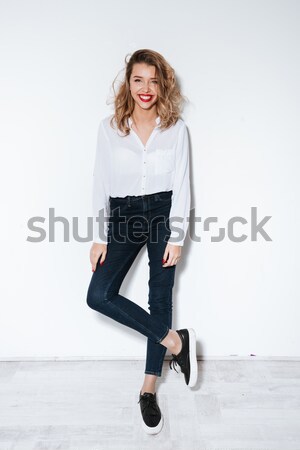 Full length portrait of a sexy fit woman in bodysuit Stock photo © deandrobot