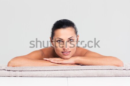 Woman lying on massage lounger Stock photo © deandrobot