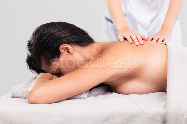 Masseur doing massage on woman body  Stock photo © deandrobot