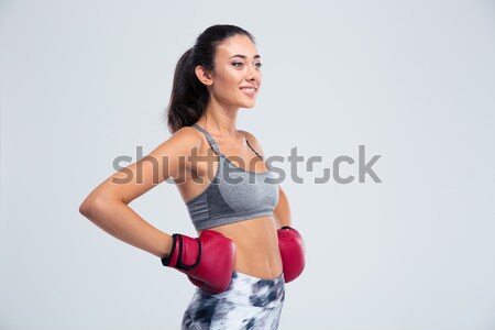 Smiling sports woman standing in boxing gloves  Stock photo © deandrobot
