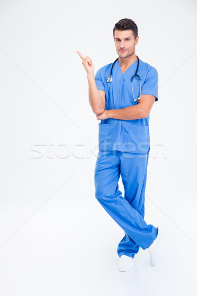 Male doctor pointing finger away Stock photo © deandrobot