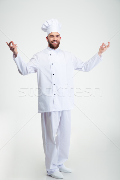 Glimlachend chef kok tonen welkom gebaar Stockfoto © deandrobot