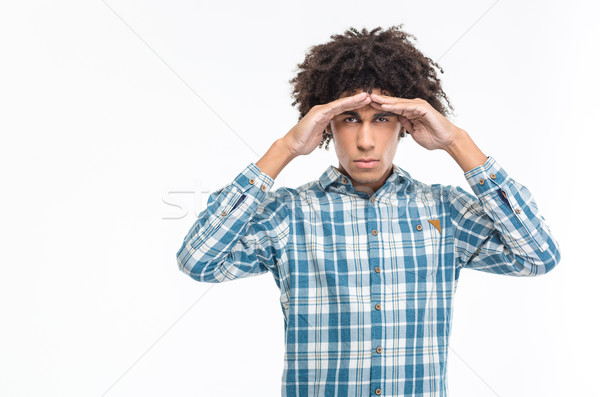 Man with curly hair looking into the distance at camera Stock photo © deandrobot