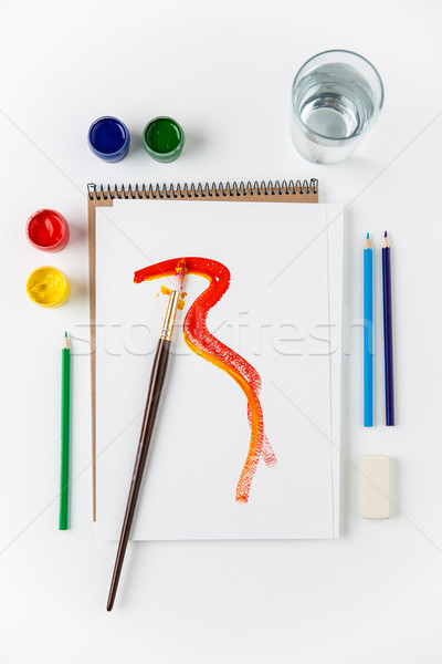 Top view of sketchbook, paintbrush, colorful brushes and pencils  Stock photo © deandrobot