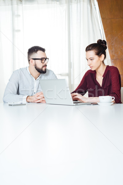 Two businesspeople working and using laptop on meeting in office Stock photo © deandrobot