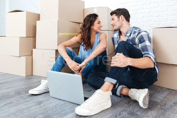 Young couple sitting on the floor of their new apartment Stock photo © deandrobot