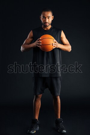 Attractive young african man with basket ball Stock photo © deandrobot
