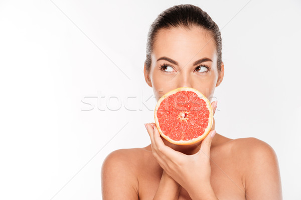 Portrait of pretty attractive young woman holding fresh grapefruit Stock photo © deandrobot