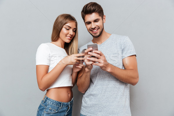 Stock photo: Nice couple looking at the telephones