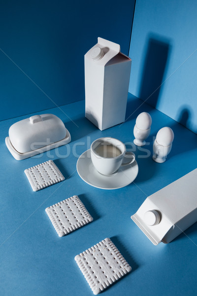 Top view of milk packs, eggs, cup, butter and cookies Stock photo © deandrobot