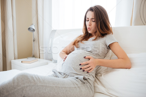 Pregnant woman with tummy-ache Stock photo © deandrobot