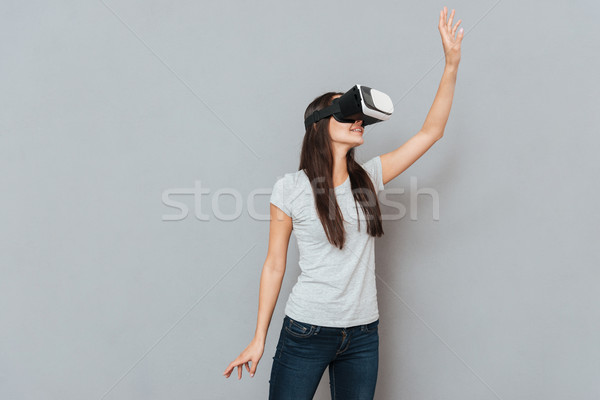 Young woman using virtual reality device Stock photo © deandrobot