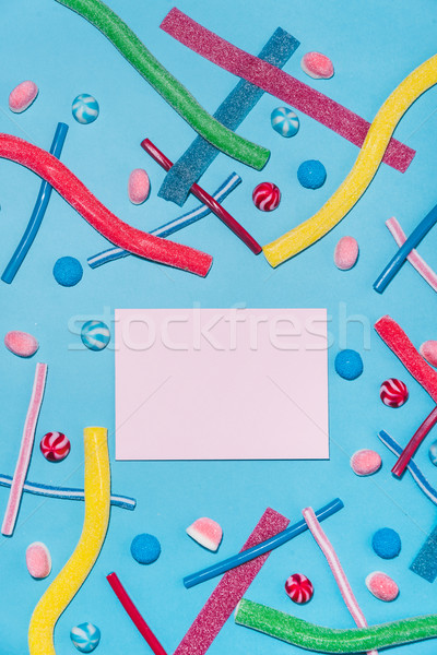 Colorful sugar candies and lollies with envelope in the middle Stock photo © deandrobot