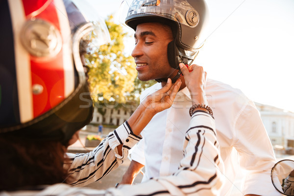 Young attractive african couple in moto halmets Stock photo © deandrobot