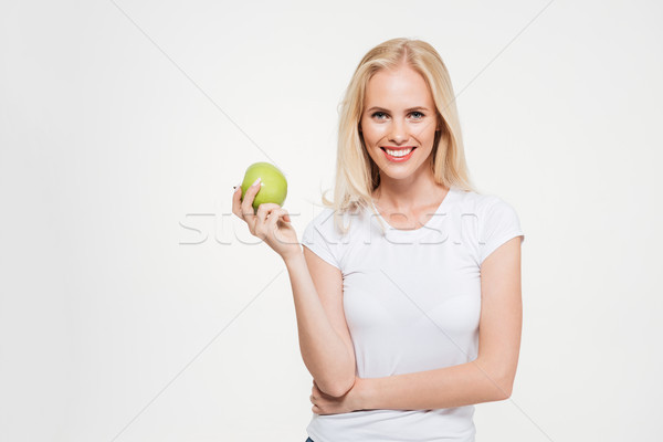 Portrait of a young healthy woman holding green apple Stock photo © deandrobot