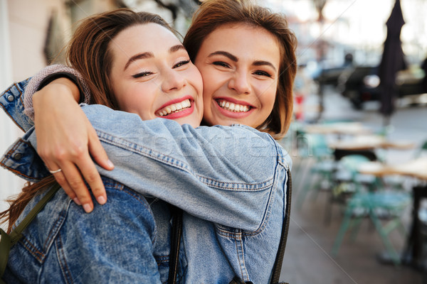 Close-up photo of two attractive happy woman friends hugging eac Stock photo © deandrobot
