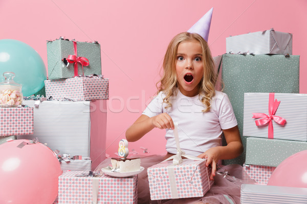 Portrait of a little girl in a birthday hat celebrating Stock photo © deandrobot