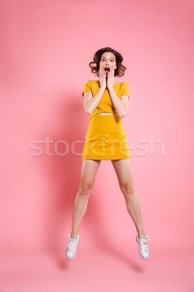 Full length portrait of attractive amazed young woman touching h Stock photo © deandrobot