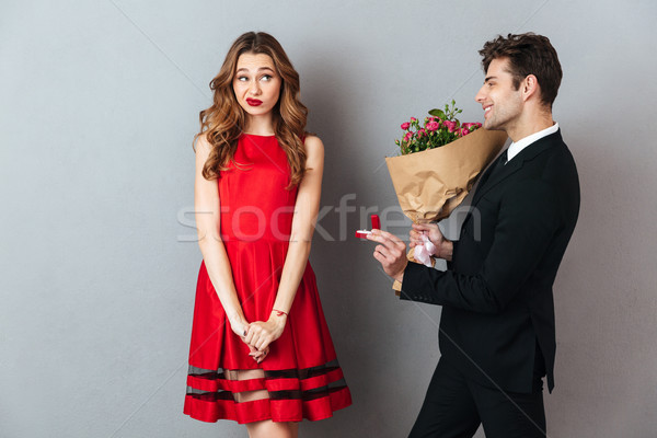 Portrait of a smiling man proposing to a girl Stock photo © deandrobot