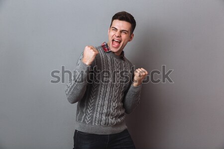 Feliz gritando morena hombre suéter Foto stock © deandrobot