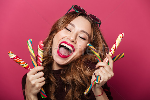 Amazing woman wearing glasses eating sweeties. Stock photo © deandrobot