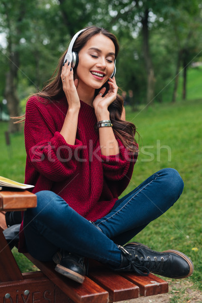 Portrait of a joyful smiling asian girl in headphones Stock photo © deandrobot