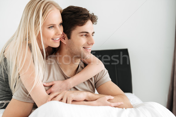 Smiling lovers hugging and looking aside Stock photo © deandrobot