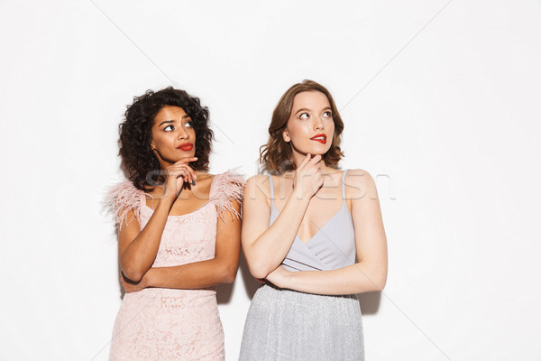 Portrait of two pretty well dressed women looking up Stock photo © deandrobot