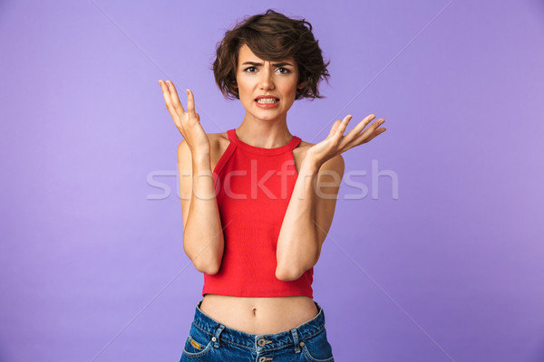 Portrait of a frustrated young girl shrugging shoulders Stock photo © deandrobot