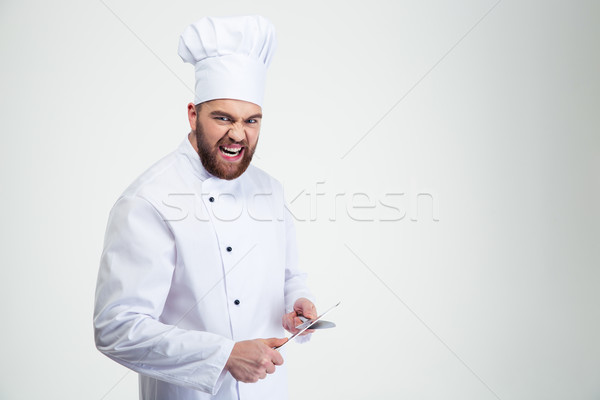 Male chef cook sharpening knife Stock photo © deandrobot