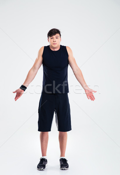 Stock photo: Full length portrait of a sports man shrugging shoulder