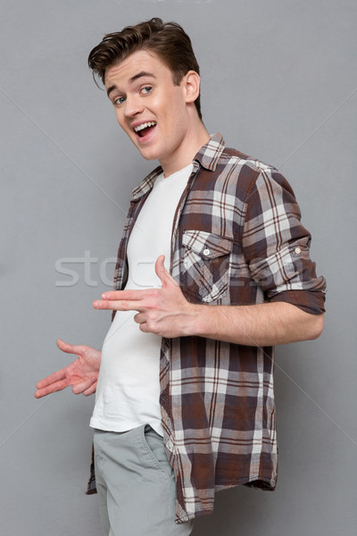 Młodych funny człowiek palce jak dział Zdjęcia stock © deandrobot
