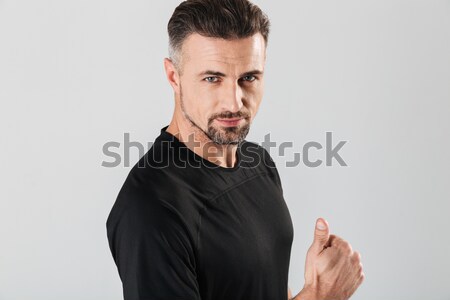 Scared dazed handsome young man with beard in sweetshirt  Stock photo © deandrobot