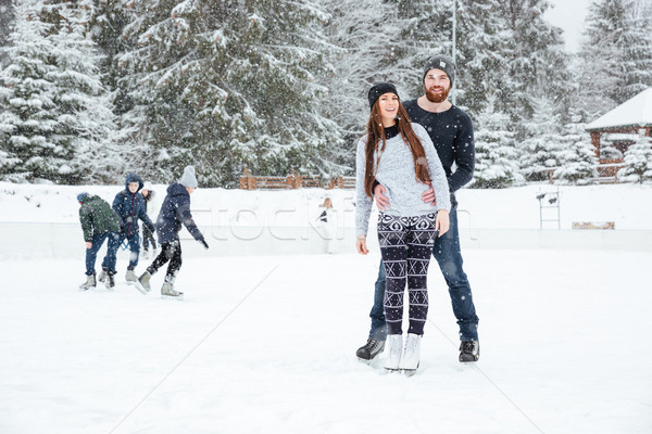 Couple in ice skates standing outdoors Stock photo © deandrobot