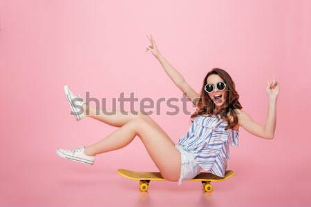 Stock photo: Stylish woman in sunglasses sucking candy