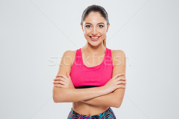 Zâmbitor sport femeie în picioare arme pliat Imagine de stoc © deandrobot