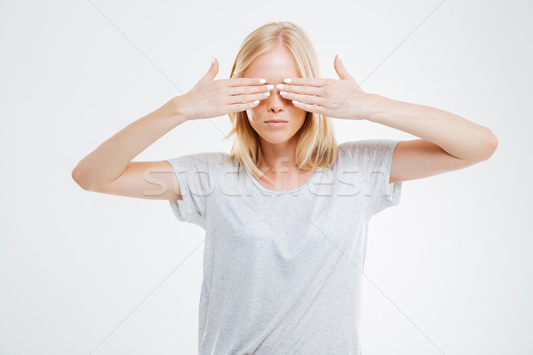 Portrait of a young woman covering her eyes with palms Stock photo © deandrobot