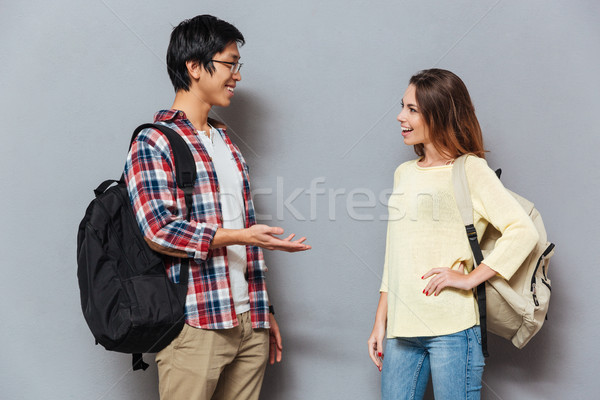 Two young interracial students with backpacks talking Stock photo © deandrobot