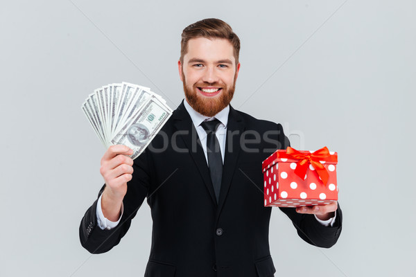 Iş adamı hediye para mutlu yakışıklı takım elbise Stok fotoğraf © deandrobot
