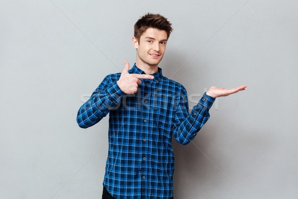 Stock photo: Young man showing at empty space