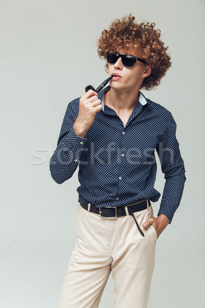 Young retro man dressed in shirt standing and posing Stock photo © deandrobot