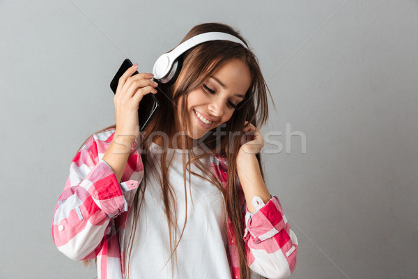 Close-up portrait of dancing young happy woman listening music w Stock photo © deandrobot