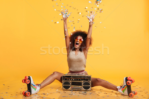 Emotional african disko woman in retro wear and roller scates th Stock photo © deandrobot
