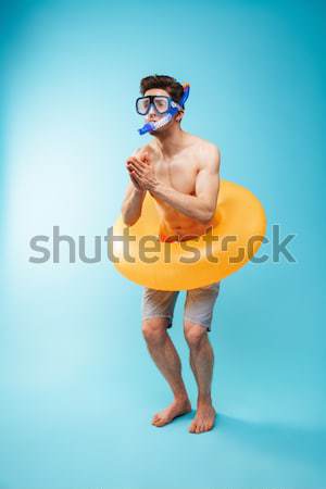 Full-length image of Happy naked man in shorts and sunglasses Stock photo © deandrobot