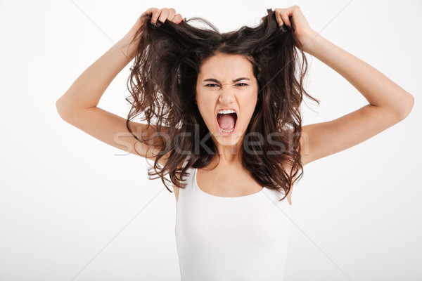 Portrait of an angry girl dressed in tank-top Stock photo © deandrobot