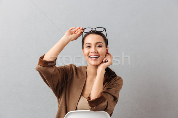 Portrait of a laughing young asian woman in eyeglasses Stock photo © deandrobot