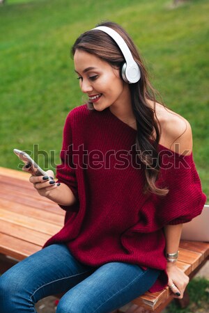 Portrait of a joyful smiling asian girl in headphones Stock photo © deandrobot